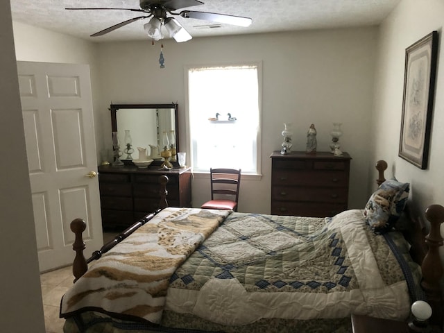 bedroom with light tile patterned floors and a ceiling fan