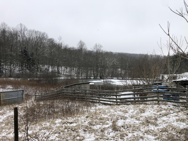 yard layered in snow with fence