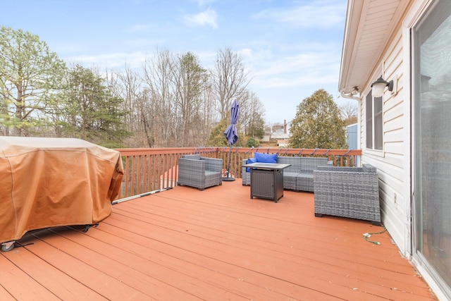 wooden deck with grilling area and an outdoor hangout area