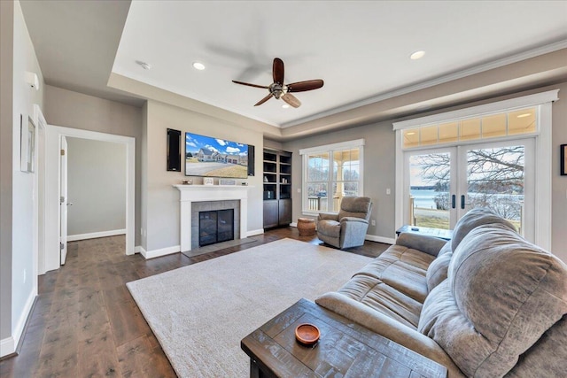 living area featuring dark wood-style floors, french doors, recessed lighting, a tiled fireplace, and baseboards