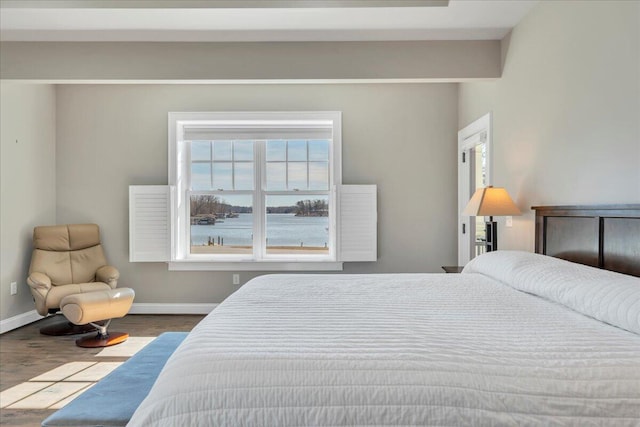 bedroom with baseboards and wood finished floors