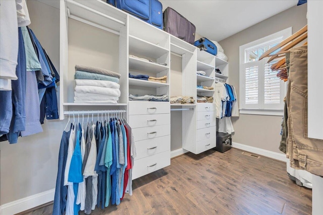 walk in closet with dark wood-style flooring and visible vents