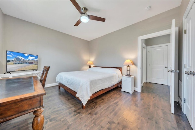 bedroom with ceiling fan, baseboards, and wood finished floors