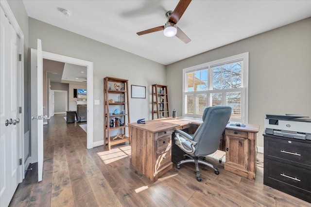 office with a ceiling fan, baseboards, and wood finished floors