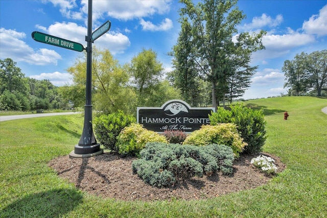 community / neighborhood sign with a lawn