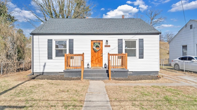 bungalow-style home featuring a front lawn