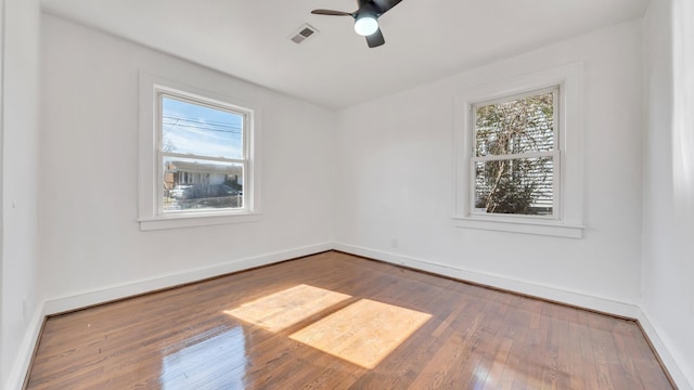 empty room featuring ceiling fan and hardwood / wood-style floors