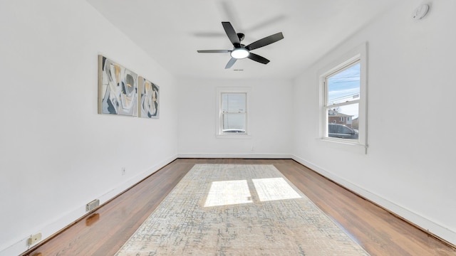 spare room featuring dark wood-type flooring and ceiling fan