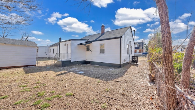 rear view of house with cooling unit