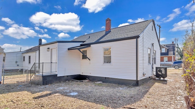 rear view of property featuring central AC unit