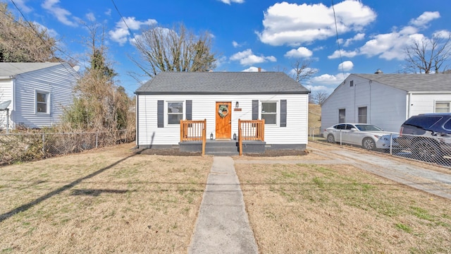 bungalow-style house with a front lawn