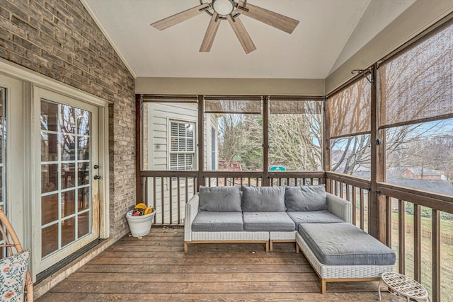 sunroom with plenty of natural light, an outdoor hangout area, and a ceiling fan