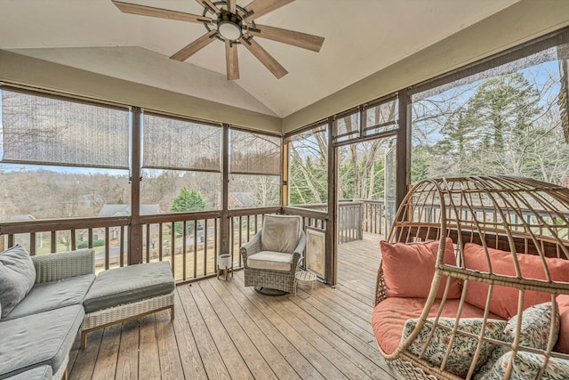 sunroom / solarium featuring a ceiling fan and plenty of natural light
