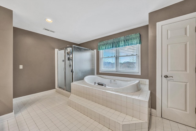 bathroom featuring a stall shower, a garden tub, tile patterned flooring, baseboards, and visible vents