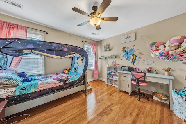 bedroom featuring light wood-type flooring, baseboards, ceiling fan, and visible vents