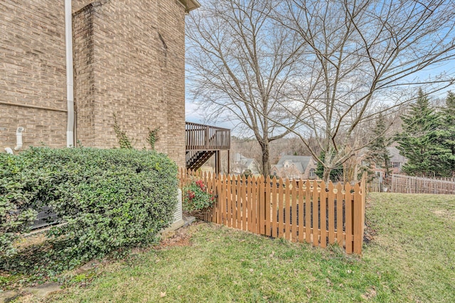 view of yard with stairs, fence, and a wooden deck