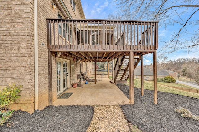 view of patio / terrace featuring a deck and stairs