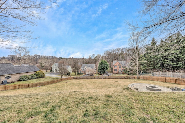 view of yard featuring an outdoor fire pit and fence
