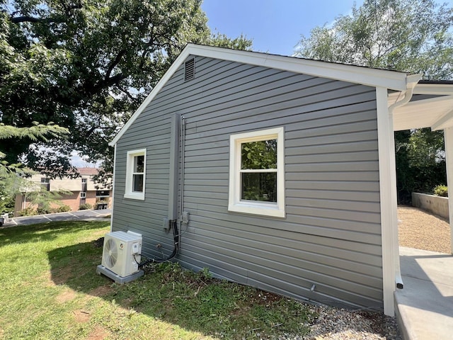 view of side of home featuring a yard and ac unit