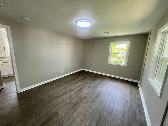 spare room featuring dark hardwood / wood-style floors