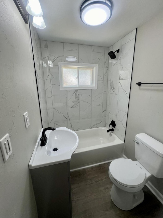 full bathroom featuring vanity, wood-type flooring, toilet, and tiled shower / bath