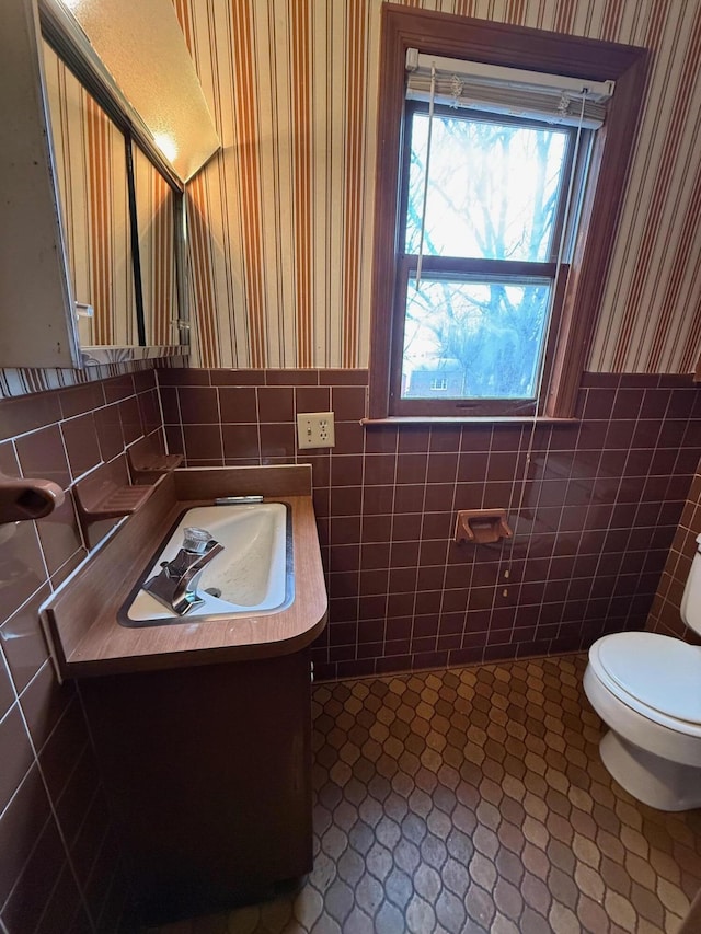45 Hillcrest Dr, Rocky Mount, VA 24151 - half bath featuring vanity, tile walls, toilet, wallpapered walls, and wainscoting