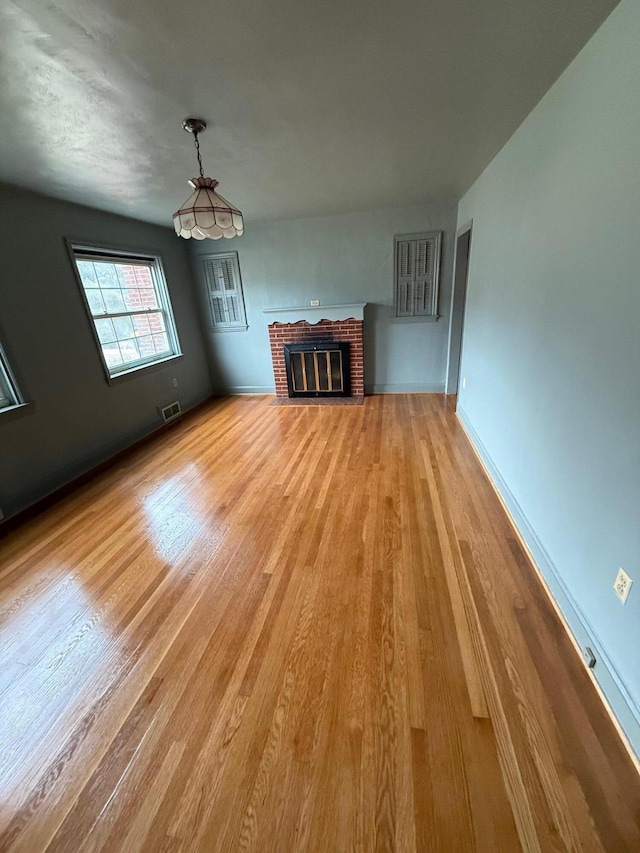 45 Hillcrest Dr, Rocky Mount, VA 24151 - unfurnished living room with light wood-style flooring, baseboards, a fireplace, and visible vents