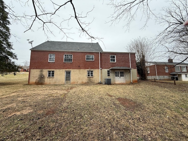 back of house with a yard and central AC unit