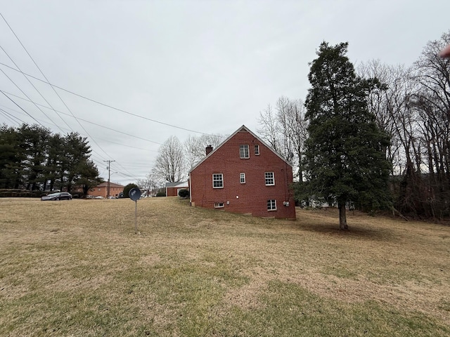 45 Hillcrest Dr, Rocky Mount, VA 24151 - view of side of home with brick siding, a yard, and a chimney