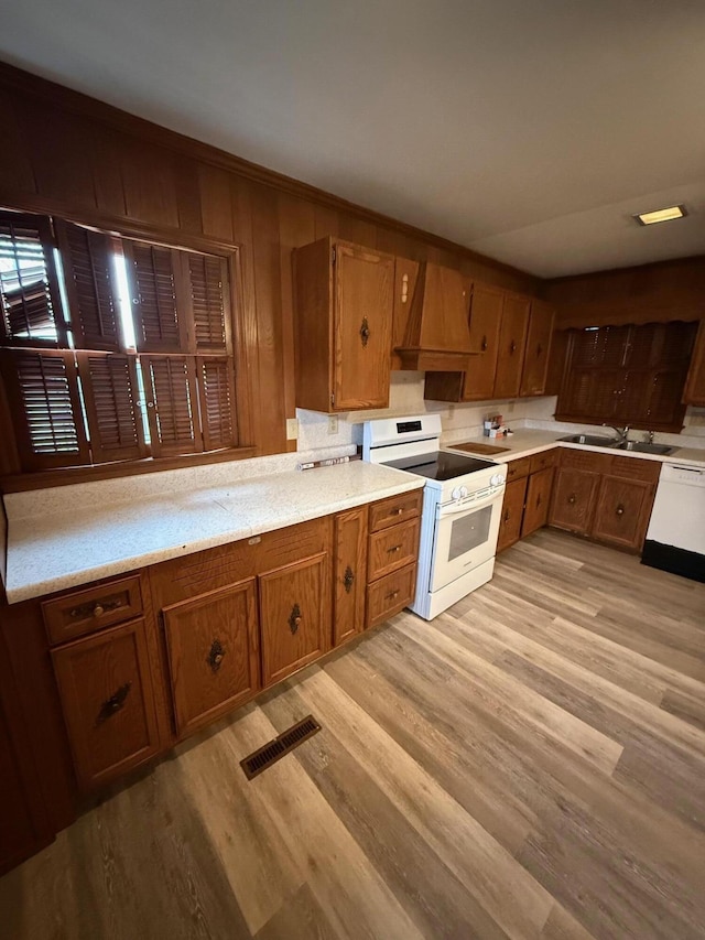 45 Hillcrest Dr, Rocky Mount, VA 24151 - kitchen featuring a sink, brown cabinets, custom exhaust hood, white appliances, and visible vents