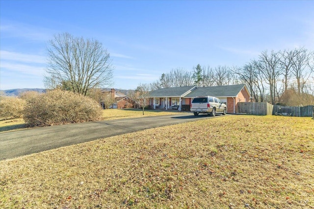 view of front of home featuring a garage and a front lawn