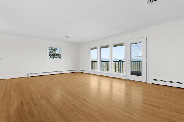 1909 Pelham Dr, Roanoke, VA 24018 - spare room featuring baseboard heating, wood finished floors, and visible vents