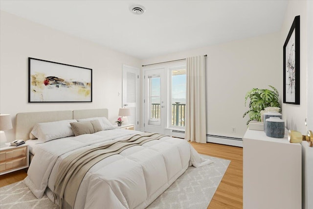 1909 Pelham Dr, Roanoke, VA 24018 - bedroom featuring light wood-style floors, access to exterior, a baseboard heating unit, and visible vents