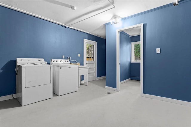 laundry area with washer and dryer, baseboards, and a baseboard radiator