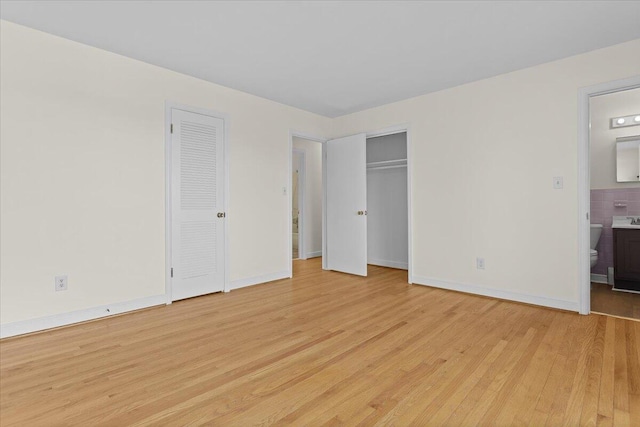 1909 Pelham Dr, Roanoke, VA 24018 - unfurnished bedroom featuring ensuite bath, light wood-style flooring, and baseboards