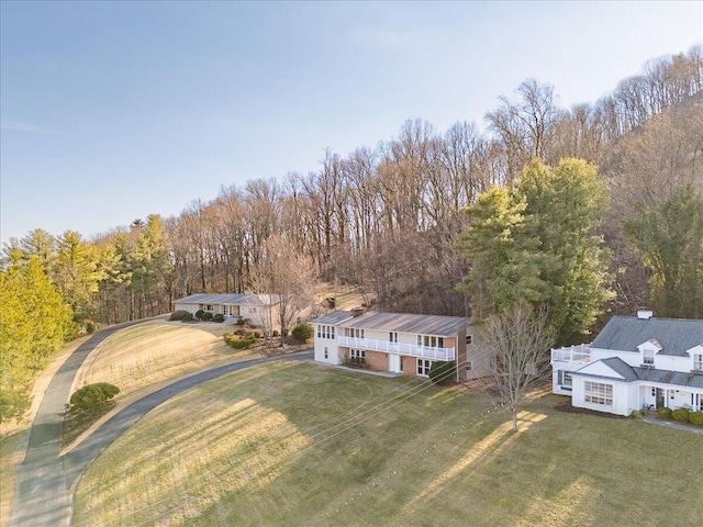 birds eye view of property with a wooded view