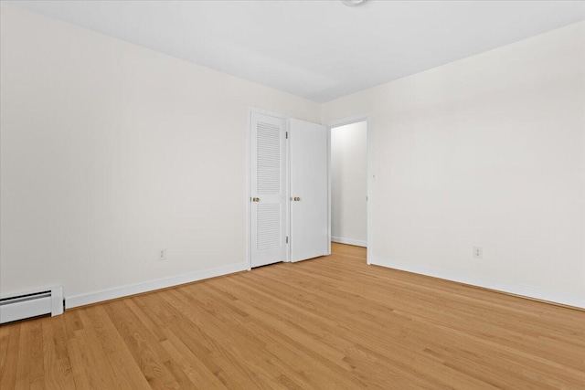 1909 Pelham Dr, Roanoke, VA 24018 - unfurnished room with a baseboard heating unit, light wood-type flooring, and baseboards