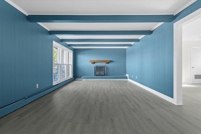 unfurnished living room featuring a baseboard radiator, a brick fireplace, beam ceiling, and wood finished floors