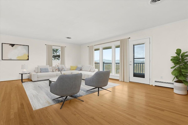 1909 Pelham Dr, Roanoke, VA 24018 - living room with visible vents, baseboards, a baseboard radiator, and light wood-style floors