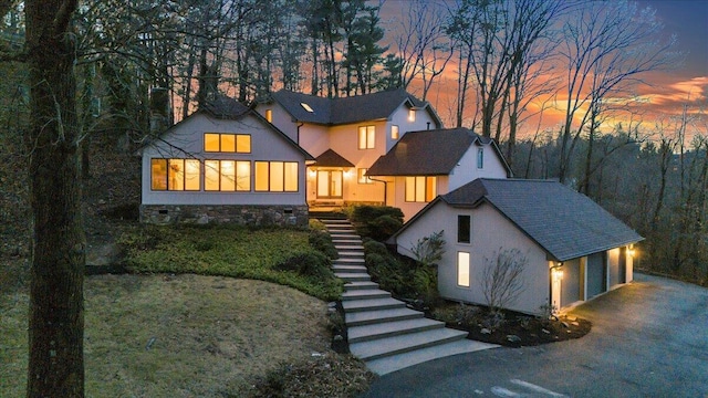 view of front of home with a garage and a sunroom