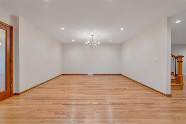3615 Dogwood Ln SW, Roanoke, VA 24015 - unfurnished room featuring stairway, light wood finished floors, recessed lighting, a chandelier, and baseboards