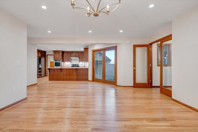3615 Dogwood Ln SW, Roanoke, VA 24015 - unfurnished living room featuring light wood-style floors, baseboards, a chandelier, and recessed lighting