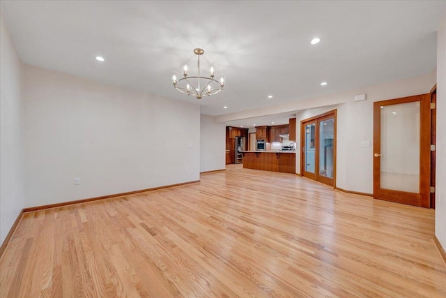 3615 Dogwood Ln SW, Roanoke, VA 24015 - unfurnished living room with light wood-style floors, a chandelier, baseboards, recessed lighting, and french doors
