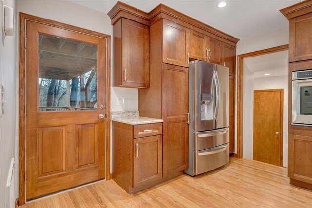 3615 Dogwood Ln SW, Roanoke, VA 24015 - kitchen featuring appliances with stainless steel finishes, brown cabinets, light wood-type flooring, and recessed lighting