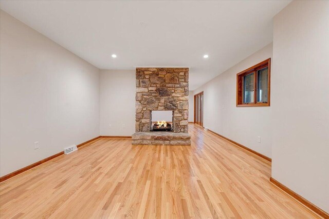 3615 Dogwood Ln SW, Roanoke, VA 24015 - unfurnished living room featuring wood finished floors, baseboards, a stone fireplace, and recessed lighting