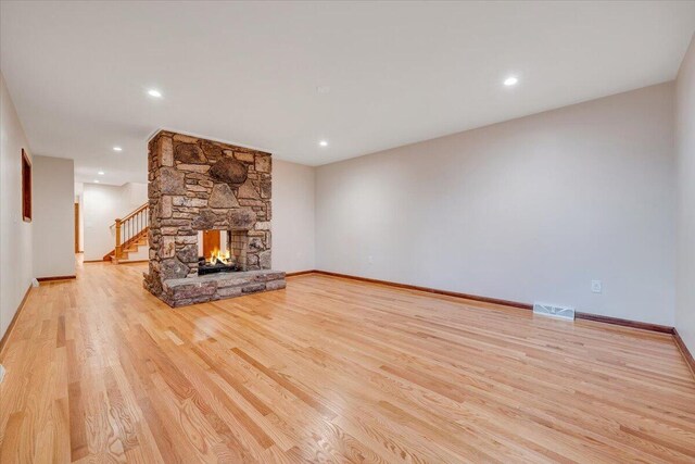 3615 Dogwood Ln SW, Roanoke, VA 24015 - unfurnished living room with light wood finished floors, recessed lighting, a fireplace, baseboards, and stairway