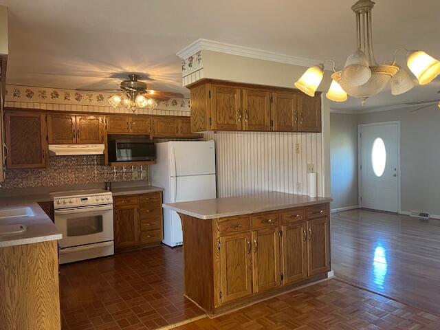 kitchen featuring decorative light fixtures, ornamental molding, dark parquet flooring, ceiling fan, and white appliances