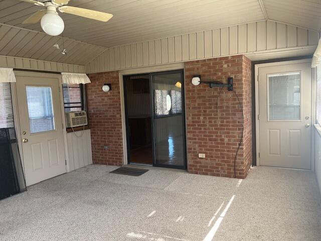 doorway to property featuring cooling unit, ceiling fan, and a patio area