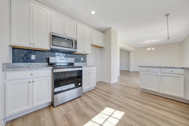 320 Woodside Dr, Salem, VA 24153 - kitchen featuring appliances with stainless steel finishes, a chandelier, backsplash, light wood-type flooring, and white cabinetry