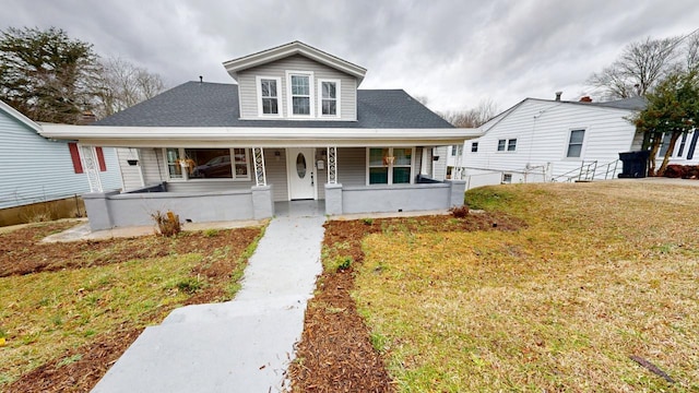 view of front of home with covered porch and a front lawn